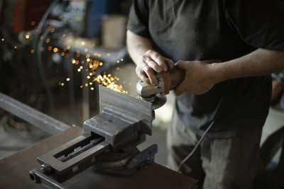 Midsection of man working at workshop