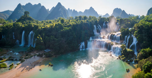 Panoramic view of waterfall in forest against sky