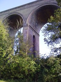 Low angle view of arch bridge against sky