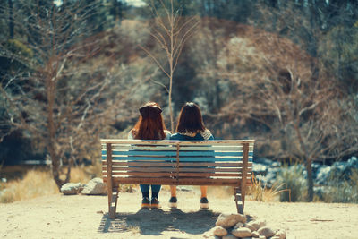 Female friends sitting on a park bench