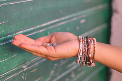 Close-up of woman's hand holding pebbles