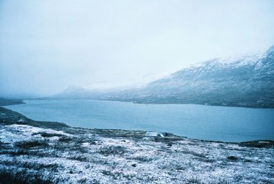 Scenic view of sea against clear sky during winter