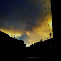 Low angle view of silhouette buildings against sky during sunset