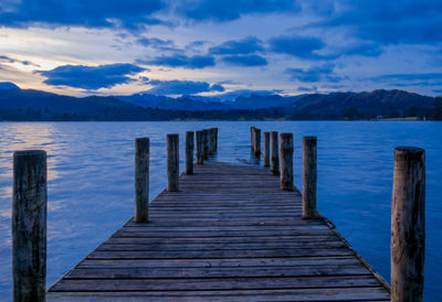 Pier over lake against sky