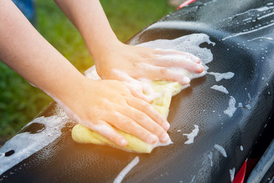 Cropped hands cleaning seat