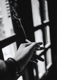 Close-up of human hand holding cigarette