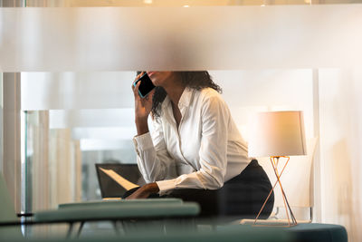 Rear view of woman using mobile phone