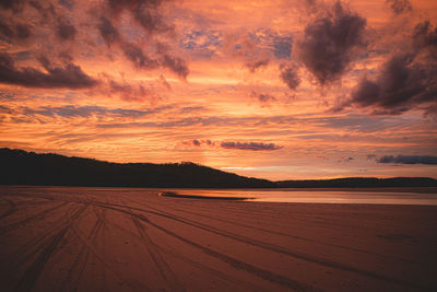 Scenic view of land against sky during sunset