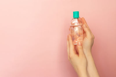 Close-up of woman hand holding bottle