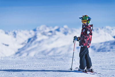 Portrait of boy skiing on snowcapped mountain