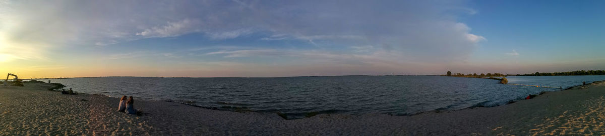 Panoramic view of beach against sky during sunset