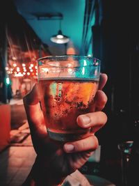 Close-up of hand holding glass of wine