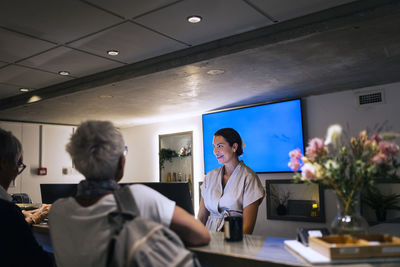 Receptionist assisting customer at health spa