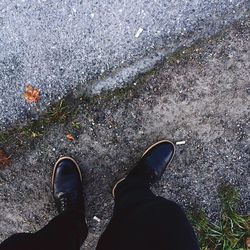 Low section of person standing on road