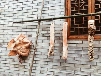 Dried meat hanging by wall at market stall