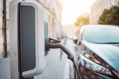 Close-up of electric charging cable charging car