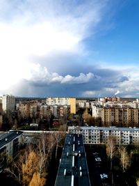 High angle view of road by buildings against sky