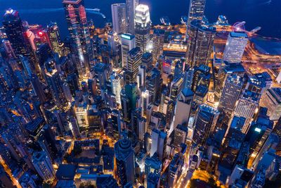 Aerial view of buildings in city against sky at dusk