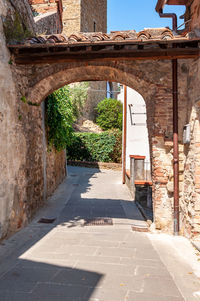 Empty alley amidst buildings in city