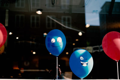 Close-up of balloons seen through window