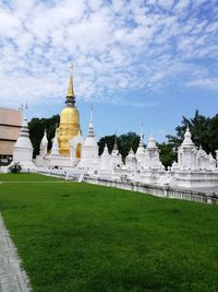 Statue of temple against cloudy sky