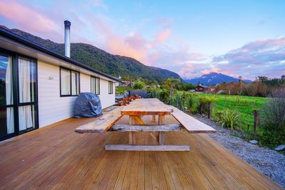 House and table by building against sky