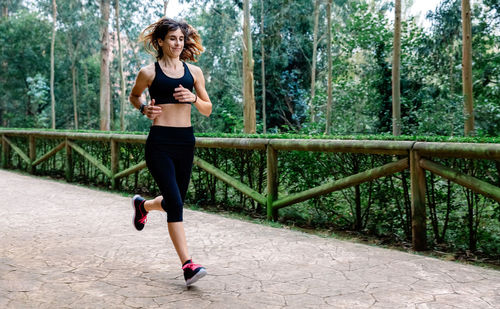 Athlete woman running through a park