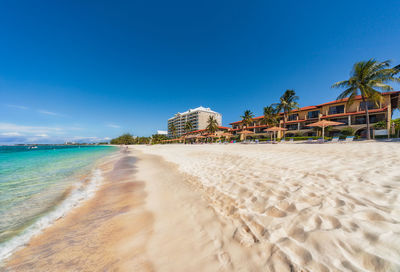 Scenic view of beach against blue sky