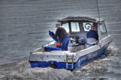 Men sitting on boat in sea