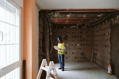 Foreman or architect working on blueprints on construction site. home improvement