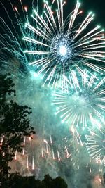 Low angle view of firework display at night