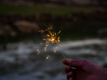 Midsection of person holding fireworks