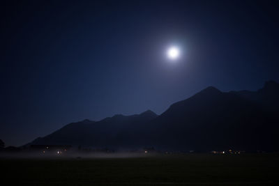 Scenic view of mountains against sky at night