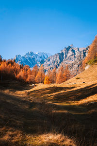 Scenic view of mountains against clear blue sky