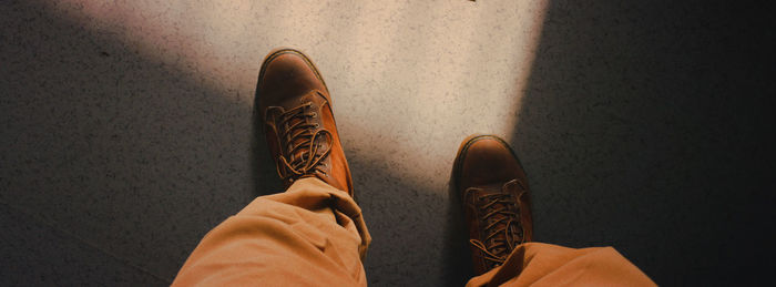 Low section of person standing on tiled floor