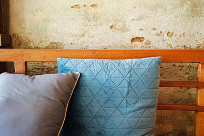 Close-up of cushion against wall at home
