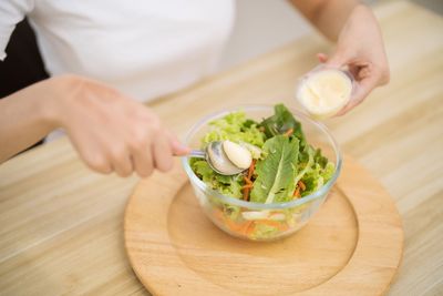 Midsection of man preparing food on table