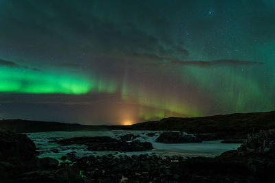 Scenic view of sea against sky at night