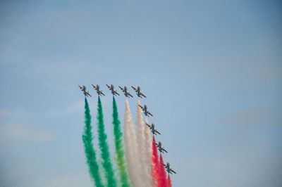 Low angle view of airplane flying against sky