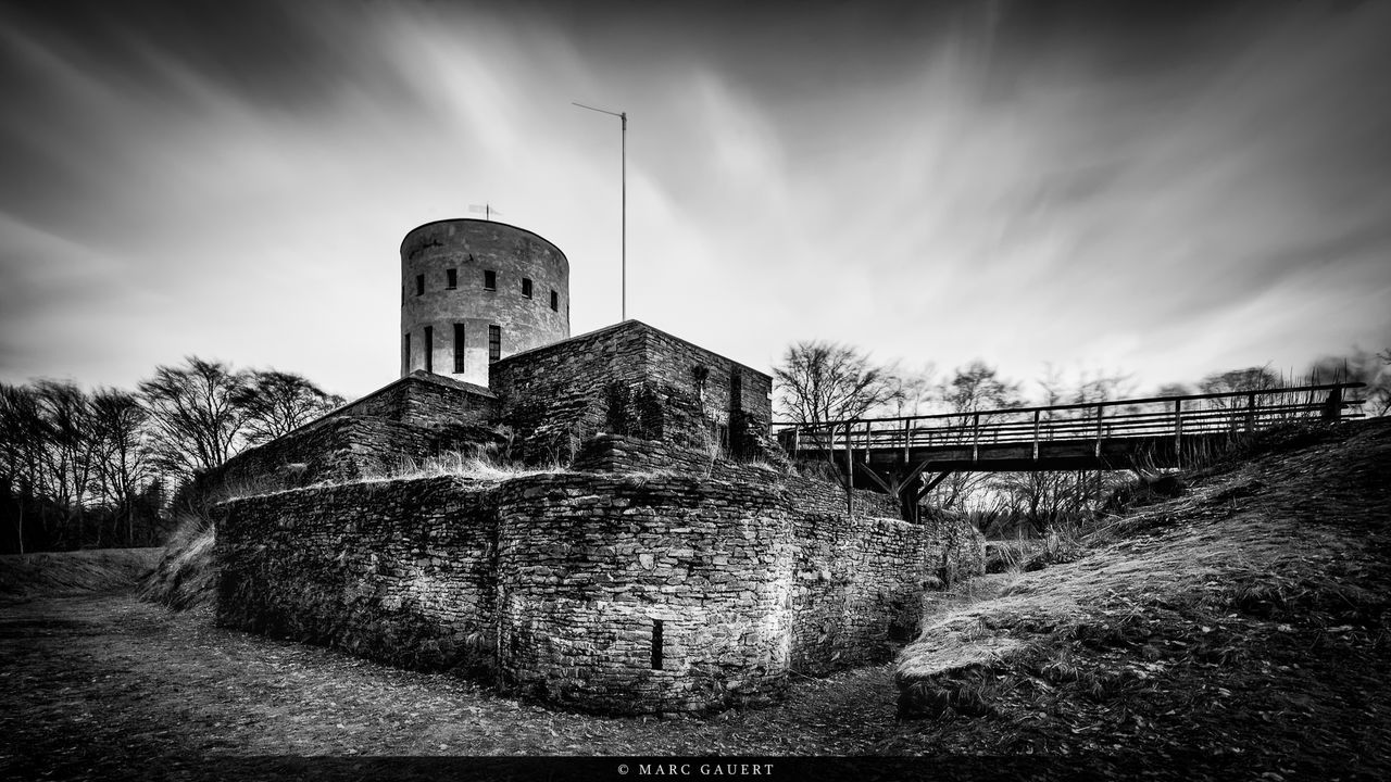 architecture, built structure, sky, building exterior, cloud - sky, tree, religion, old, church, history, spirituality, place of worship, cloud, abandoned, tower, stone wall, cloudy, field, no people