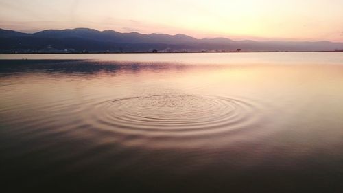 Scenic view of lake at sunset