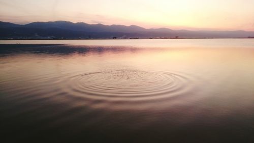 Scenic view of lake at sunset