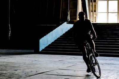 High angle view of man cycling on tiled floor