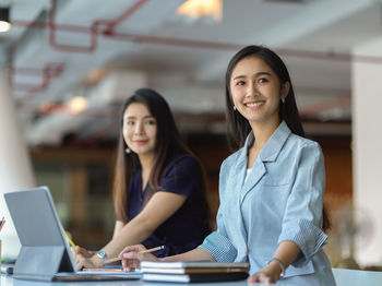 Smiling businesswomen working at office