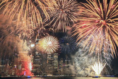 Low angle view of firework display at night