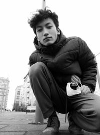 Portrait of young man sitting outdoors