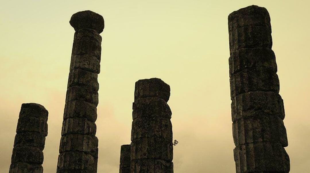 LOW ANGLE VIEW OF TOWER AT SUNSET