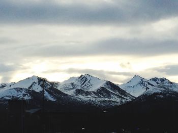 Scenic view of snow covered mountains against sky