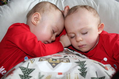High angle view of boy sleeping on bed
