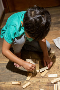 High angle view of boy playing with toy blocks at home